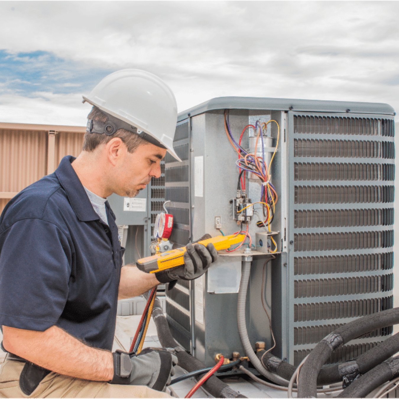 Lakeshore Heating & Cooling HVAC technician servicing a system